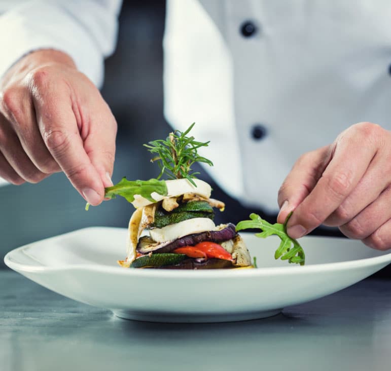 A chef plating a gourmet meal, Food Industry Consulting