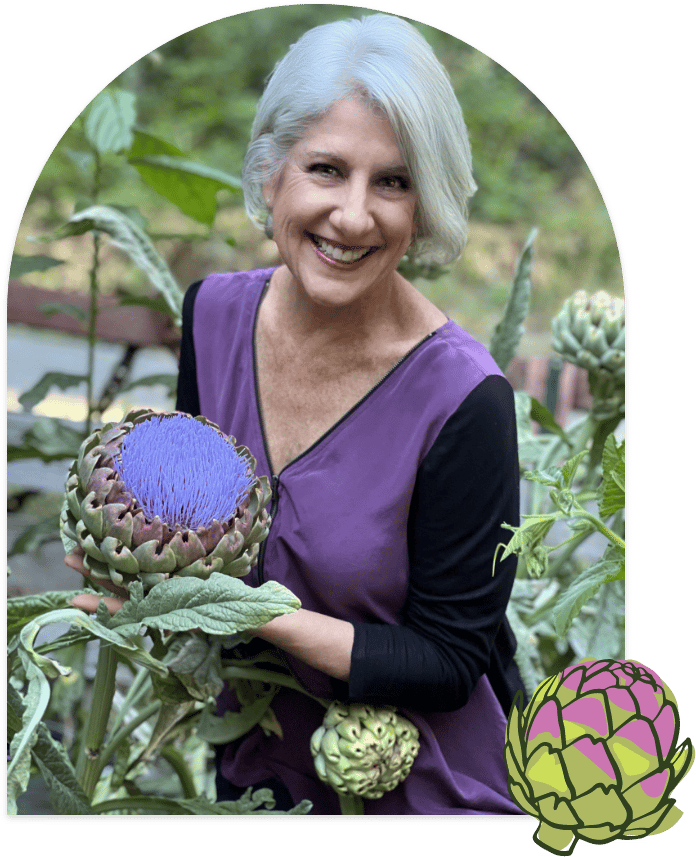 Darcie Ellyne, Food Industry Consultant and Nutritionist, stands in a garden with large colorful blooming artichokes